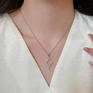 Elegant silver star pendant necklace with cubic zirconia worn by model with white dress