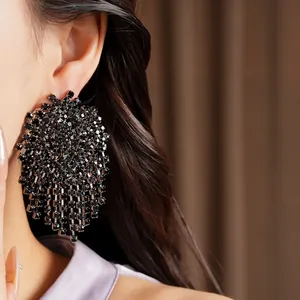 Dramatic black rhinestone tassel earrings shown on model for a statement look.