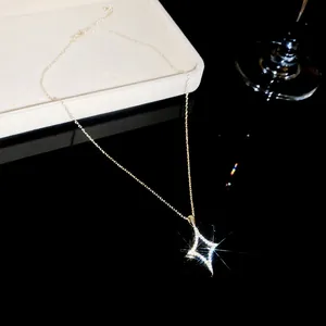 Macro detail of a sparkling 18K gold plated four-pointed star necklace with pavé zirconia