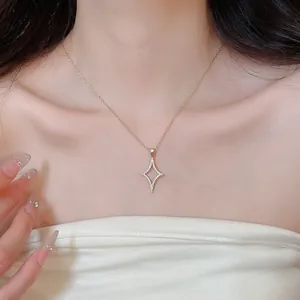 Close-up of 18K gold plated necklace with sparkling starburst pendant on female model