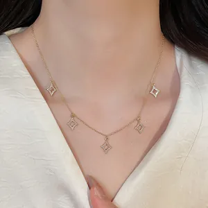Detail showing a gold-plated necklace with five zircon-encrusted rhombus charms