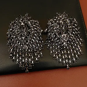 Close-up detail of black rhinestone geometric tassel earrings featuring a fringe design