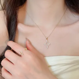 Detailed view of an 18K gold plated zircon starburst necklace and matching open ring set