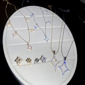 Close-up detail of 18K gold plated zircon star jewelry set including necklaces and rings.