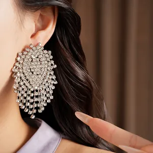 Detailed close-up showing the sparkling silver-toned rhinestone tassel earrings