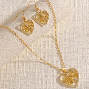 Detailed close-up of gold-plated heart necklace and earrings set with MaMa engraving