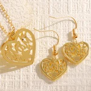 Detailed view of gold heart-shaped Mom pendant and matching drop earrings jewelry set