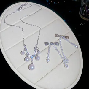 Elegant close-up of French vintage zircon pearl necklace and bow earring jewelry set