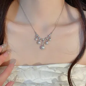 Detailed macro view of an elegant French retro zircon and pearl necklace on model's neck