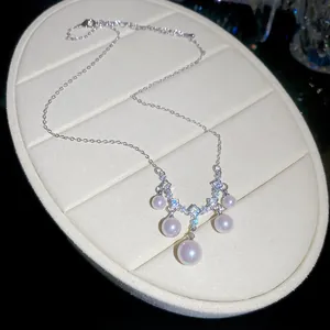 Elegant vintage pearl and cubic zirconia necklace displayed on a white velvet jewelry pad