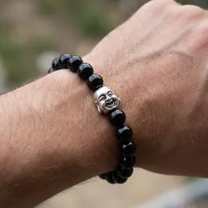 Detailed view of men's tiger eye and black agate beaded bracelet with silver Buddha head