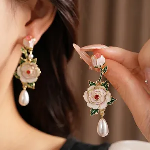 Elegant silver needle enamel rose earrings featuring teardrop pearls and red crystals