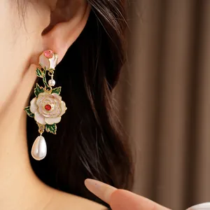 Detail shot of vintage floral earrings with teardrop pearls on an Asian model's ear