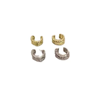 Set of four gold and silver cross-layered ear cuffs for non-pierced ears.