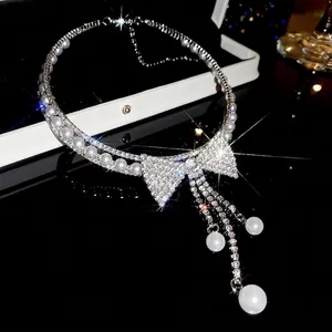 Close-up of sparkling bow tassel pearl necklace with exquisite diamond details for banquet