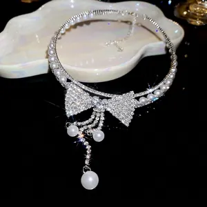 Exquisite close-up of sparkling rhinestone bow choker with dangling pearl tassel fringe