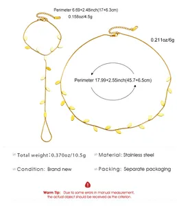 Detail view of elegant gold stainless steel leaf charm necklace and finger-loop bracelet set
