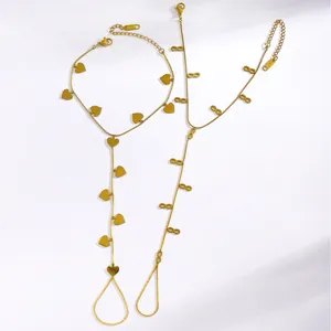 Detail showing gold stainless steel heart and infinity finger bracelets on white background
