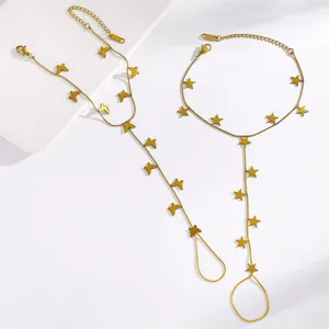 Detail view of gold stainless steel hand harness bracelets with butterfly and star charms.