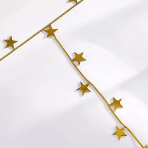 Close-up detail of golden stainless steel star hand harness bracelet chain