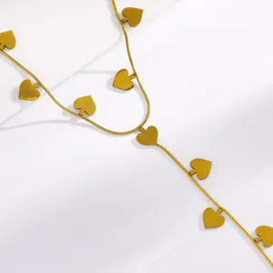 Close-up of gold stainless steel hand chain with delicate spade charms