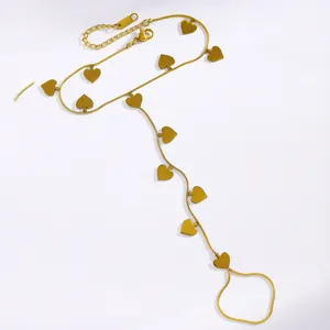 Detailed view of a gold stainless steel hand harness featuring flat heart pendants.