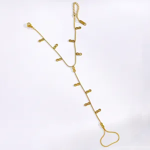 Close-up of gold stainless steel hand harness featuring multiple infinity symbols