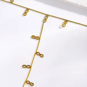 Detailed close-up of a gold stainless steel hand back chain with infinity charms.