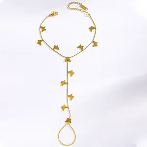Detailed view of a gold butterfly finger ring bracelet made of stainless steel with charms