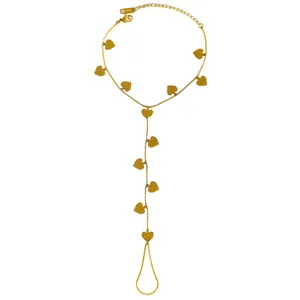 Gold stainless steel hand back chain bracelet featuring dangling heart charms