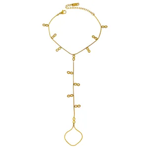 Detailed view of a gold stainless steel hand harness with infinity symbol charms