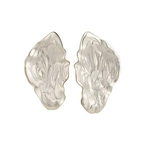 Irregular metal leaf stud earrings with textured champagne gold finish for modern elegant style