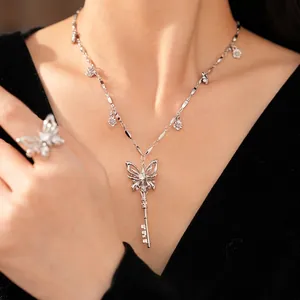 Elegant silver-tone butterfly key necklace and ring set adorned with sparkling zirconia