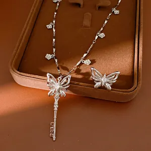 Detailed view of elegant silver zircon butterfly key necklace and ring set with flowers.