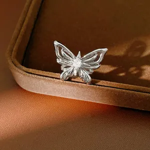 Detailed macro shot of a silver butterfly jewelry set with a sparkling zircon centerpiece