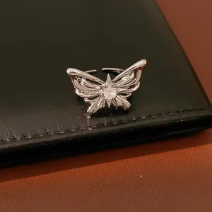 Detailed macro view of a silver butterfly adjustable ring featuring a central zircon stone