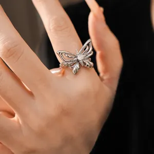 Detailed macro shot of an elegant silver butterfly ring with a sparkling clear zircon.