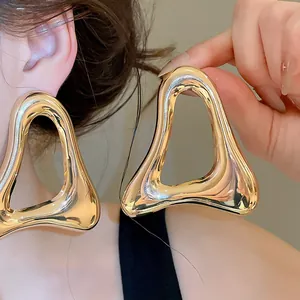 Exaggerated large vintage gold hollow triangle stud earrings with smooth metallic finish