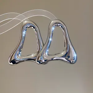 Macro shot showing the polished silver surface and hollow triangle design of these metal earrings