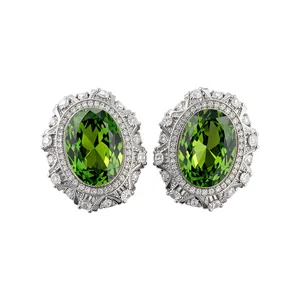 Elegant vintage silver clip-on earrings with a large green oval resin and rhinestone halo