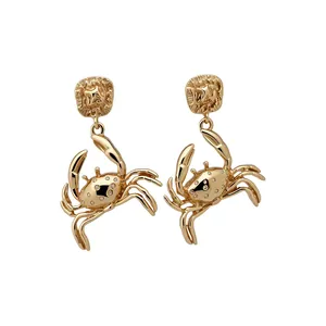 Exaggerated golden crab dangle earrings with ocean-inspired aesthetic design