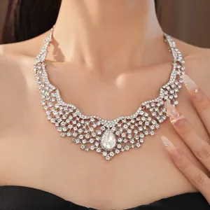 Close-up of elegant silver necklace with teardrop crystal and rhinestone floral detail