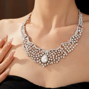 Detailed view of ornate silver palace style necklace with sparkling teardrop crystal