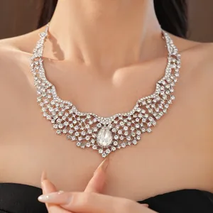 Detail of luxury teardrop rhinestone necklace in elegant silver-toned palace style design.