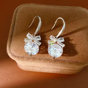 Boucles d'oreilles nœud en zircon sur une boîte à bijoux en peluche marron élégante