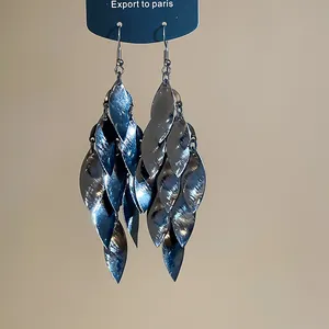 Detail view of vintage metal leaf fringe dangle earrings with gunmetal finish.