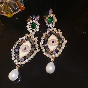 Exquisite detail of vintage Baroque eye earrings with sparkling rhinestones and elegant pearl drops