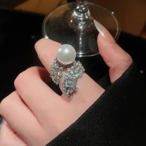 Elegant silver zircon ring featuring a large white pearl centerpiece on a model's hand.