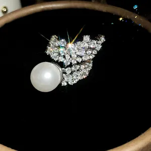 Macro detail of luxury ring featuring full zircon cluster and large white pearl luster
