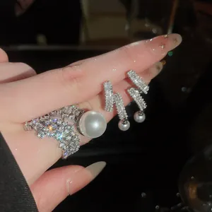 Detailed close-up of refined zircon and pearl ring and earrings set with elegant luster
